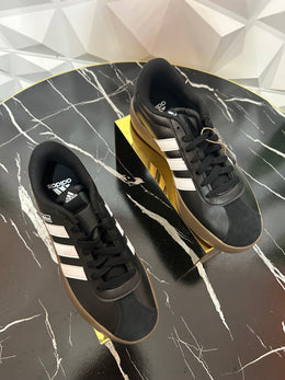 Black three stripe sneakers