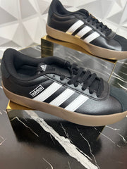 Black three stripe sneakers